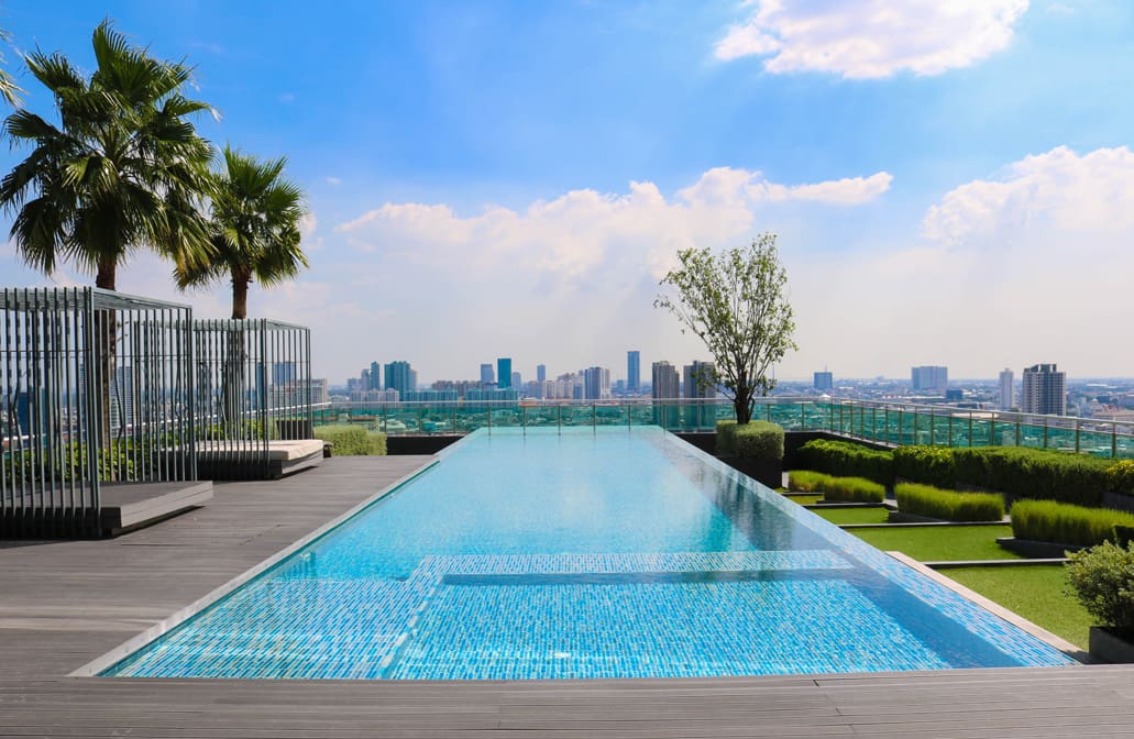 A large swimming pool with a view of the city.